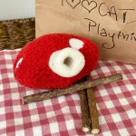 Cat chewing and playing with Clawcove Red Mushroom Silvervine Cat Toy, enjoying stress relief and dental care.
