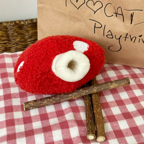 Cat Chewing on Clawcove Red Mushroom Silvervine Cat Toy - Fun, Chewing, and Dental Health Cat chewing and playing with Clawcove Red Mushroom Silvervine Cat Toy, enjoying stress relief and dental care.