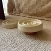 Side view of the ceramic slow feeder cat bowl with a raised wooden stand for better posture.