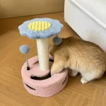 A kitten jumping onto the platform of the small cat scratching post.