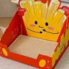 A cat scratching the sturdy paperboard surface of the cheesy fries cat scratcher.