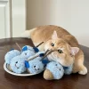 A happy cat playing with the Matatabi catnip chew toy, rolling and kicking it.