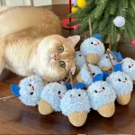 A happy cat playing with the Matatabi catnip chew toy, rolling and kicking it.