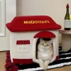 A cozy tabby cat snuggled up inside the McDonald's-themed pet bed, enjoying a restful nap.